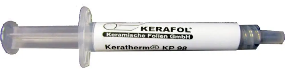 Spritze mit Wärmeleitpaste, weißem Körper und transparenter Kappe, beschriftet mit "Kerafol" und "Keratherm KP 98". Produkt stammt von der Marke Wolf.